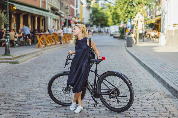 young woman riding a bicycle in the city - Photo, Image