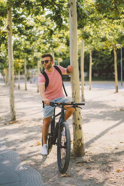 young man riding bicycle on the street - Fotoğraf, Görsel