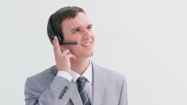 Happy businessman using a headset - Кадри, відео