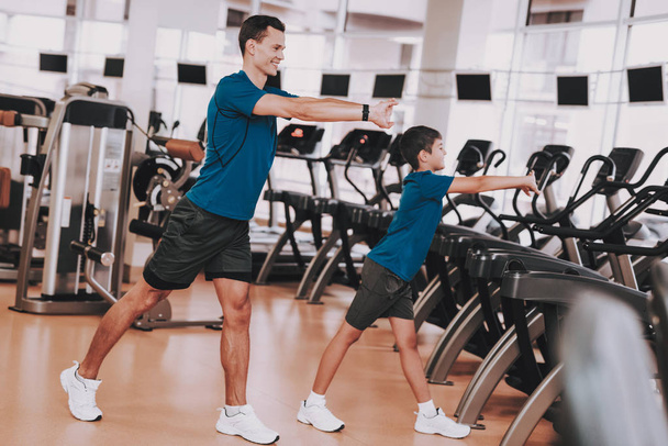 Young Father and Son Preparing for Training in Gym. Healthy Lifestyle Concept. Sport and Training Concepts. Modern Sport Club. Sport Equipment. Family Sport. Running Tracks. Parent with Child. - 写真・画像
