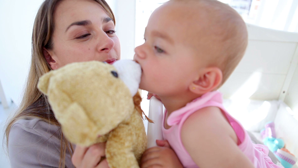 Baby girl kissing her teddy bear - Felvétel, videó