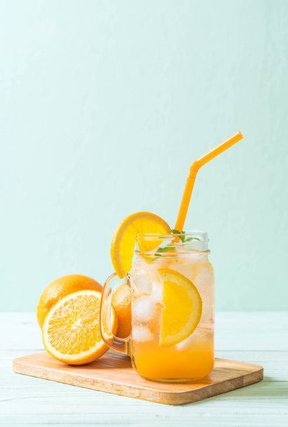 orange juice with soda on wood table - Fotoğraf, Görsel