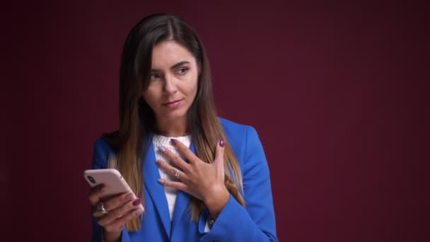 Closeup portrait of attractive caucasian female browsing on the phone and reaction to social media posts - Filmati, video