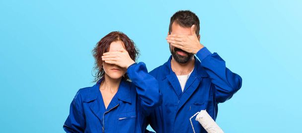 Painters covering eyes by hands. Do not want to see something on colorful background - Fotoğraf, Görsel