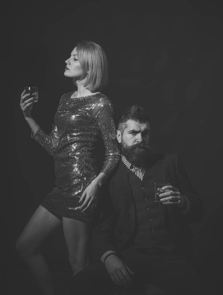 Man and woman in fancy clothes drink wiskey - Zdjęcie, obraz