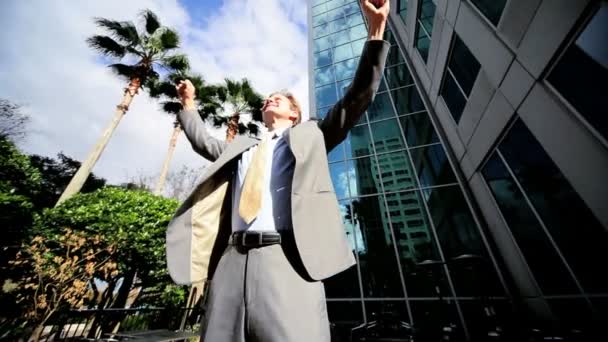Businessman Triumphant Outside City Buildings - Video