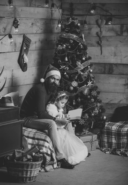 christmas happy man and small girl child read book - Foto, imagen