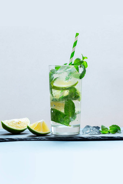 Drink of lime and mint in a glass on the table - Foto, imagen