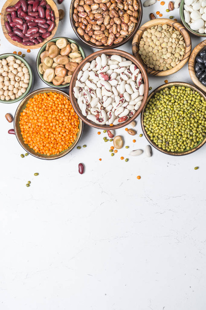 Legumes, lentils, chikpea and beans assortment on white. - Fotó, kép