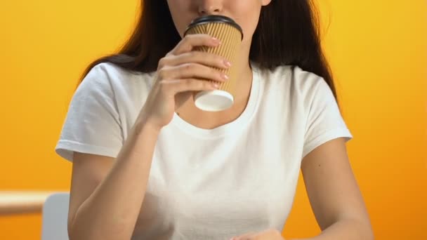 Smiling female drinking flavored tea from carton cup, enjoying taste of beverage - Imágenes, Vídeo