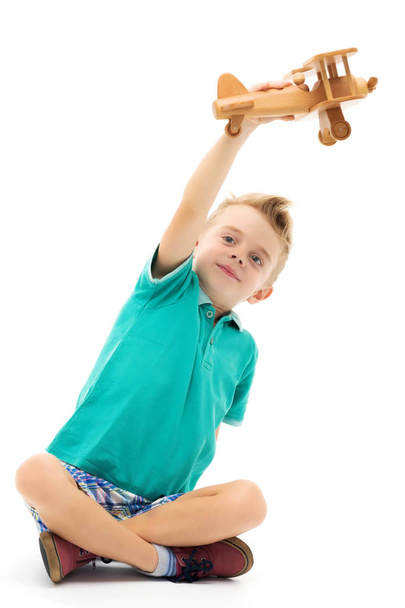 Little boy playing with wooden plane - Foto, Imagem