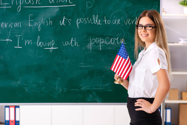 Young female english language teacher standing in front of the b - Photo, Image