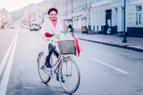 Positive delighted female person riding her bicycle - Foto, Imagem