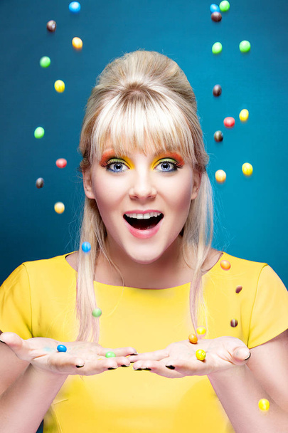 красива блондинка з багатьма барвистими цукерками
 - Фото, зображення
