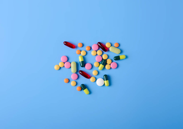 Pills capsules medicine health on blue background top view - Valokuva, kuva