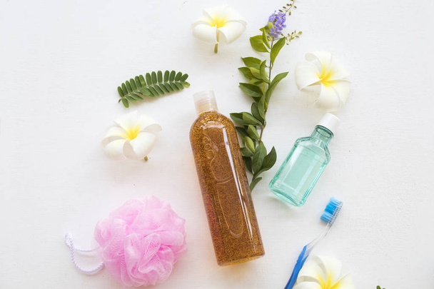 liquid soap exfoliating body wash smooth skin natural extract tamarind health care body skin and mouthwash ,toothbrush health care for oral cavity  with white flowers frangipani arrangement on background white  - Photo, Image