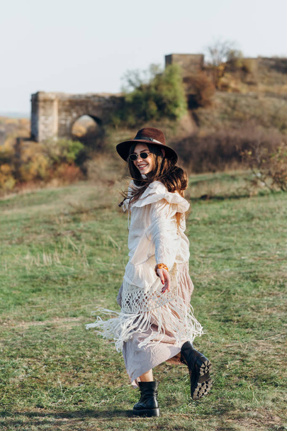 Beautiful young boho woman walking on nature. Freedom lifestyle - 写真・画像