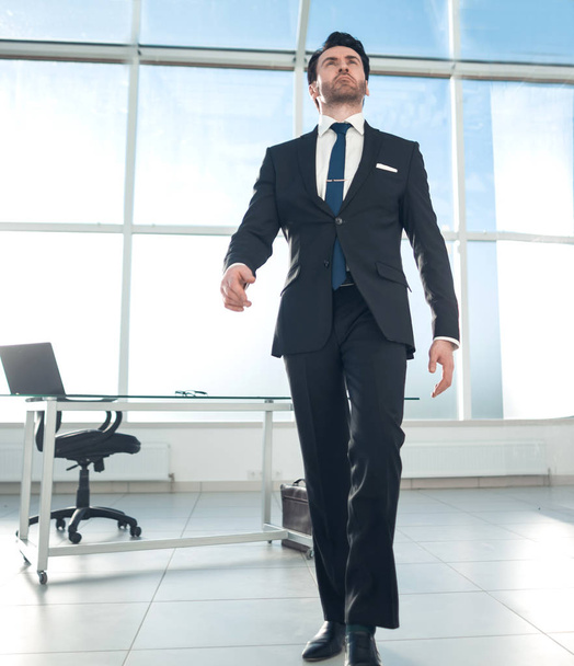 modern businessman standing in a bright office - Fotó, kép