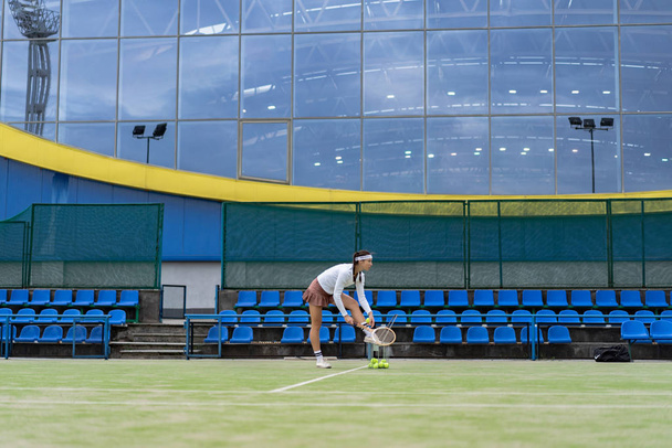 Female tennis player on green court grass - Φωτογραφία, εικόνα
