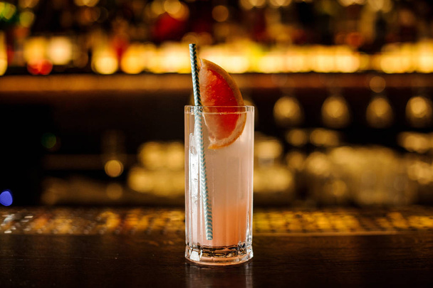 Cocktail with grapefruit on the wooden steel bar counter - 写真・画像