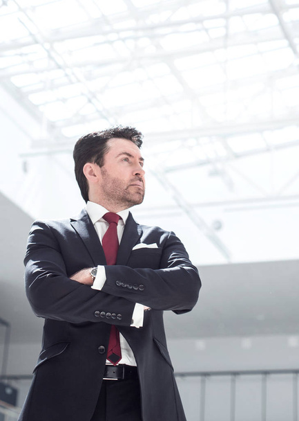 confident businessman standing in a spacious office - Foto, Imagen