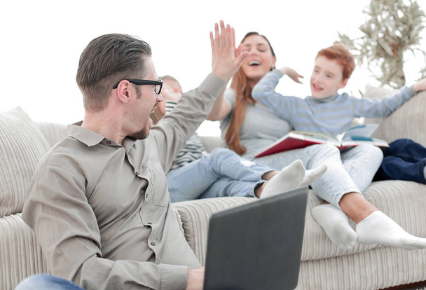 happy family giving high five in their living room - Φωτογραφία, εικόνα