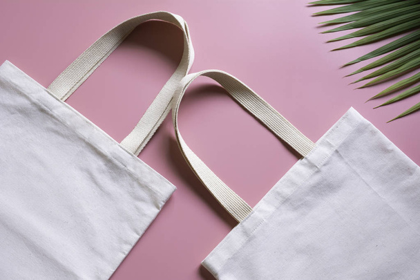 White tote bag canvas fabric. Cloth shopping sack mockup with copy space. - 写真・画像