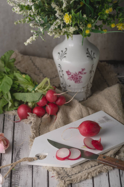 Bio radishes cuttting on wood table, food photography - Fotó, kép