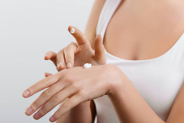 Hand Skin Care. Women use body lotion on your arms. Female applying cream to her hands - Fotó, kép