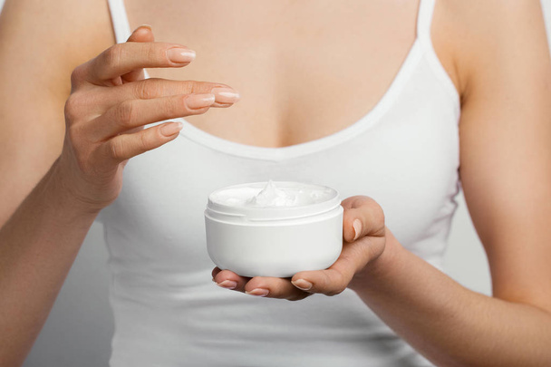 Hand Skin Care. Close Up Of Female Hands Holding Cream Tube, Woman Hands With Natural Manicure Nails Applying Cosmetic Hand Cream On Soft Silky Healthy Skin. Beauty And Body Care Concept - Φωτογραφία, εικόνα