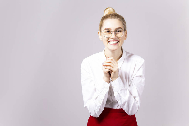 Studio shot of gorgeous young blonde business woman wearing round eyeglasses, white cotton blouse top & sexy tight red skirt. Gray isolated background, copy space, close up, portrait - Zdjęcie, obraz