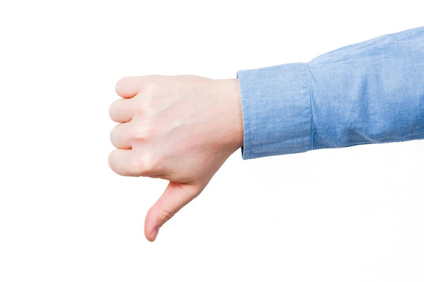 Thumb down male hand In blue shirt. On a white bakground. Isolated. - Photo, Image
