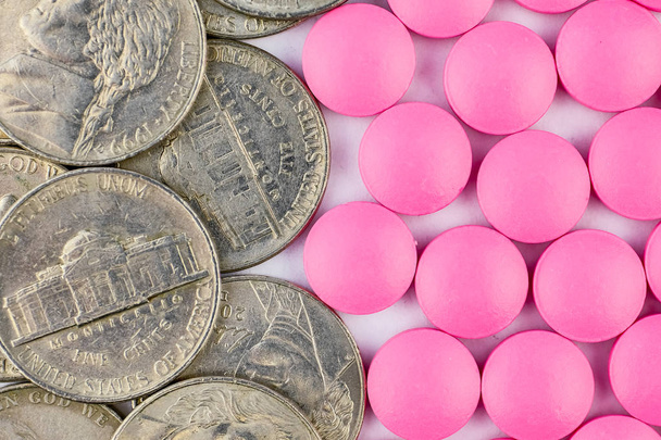 Pink pills with coins top view. Close up. Success in the drug business. - Photo, Image