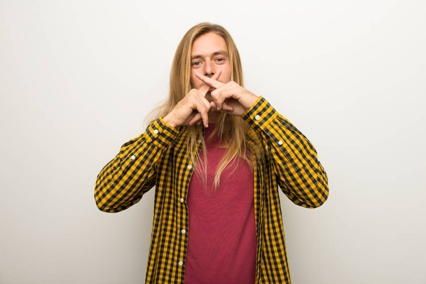 Muž s blond vlasy s dlouhými vlasy a kostkovanou košili známek mlčení gesto - Fotografie, Obrázek