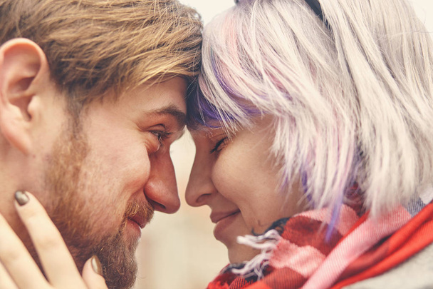 Romantic happy couple face to face close up portrait, smiling man and woman in love getting closer for first kiss, sensual sincere lovers touching noses with eyes closed, enjoying intimacy tenderness - Photo, Image