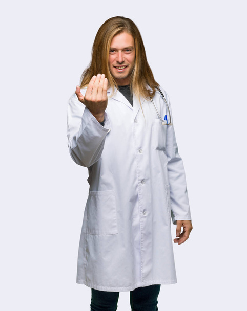 Doctor man inviting to come with hand. Happy that you came on isolated background - Foto, Imagen