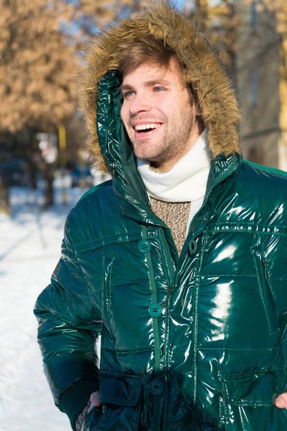 Winter fashion. Warm clothes. Happy man on winter holidays. Snowy weather. Trendy winter coat. Vacation and traveling in winter. Man. It is cold outside. Forest in snow. Fresh air. Feeling frosty - Photo, Image