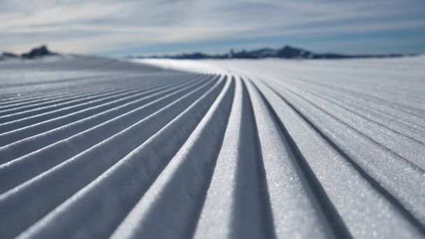 Prepared ski slope with a snow lines - Foto, Imagen