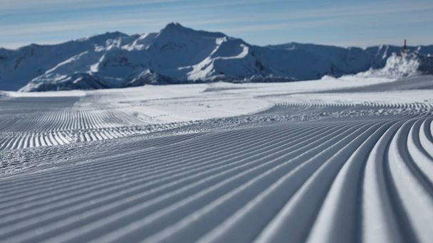 Prepared ski slope with a snow lines - Foto, imagen