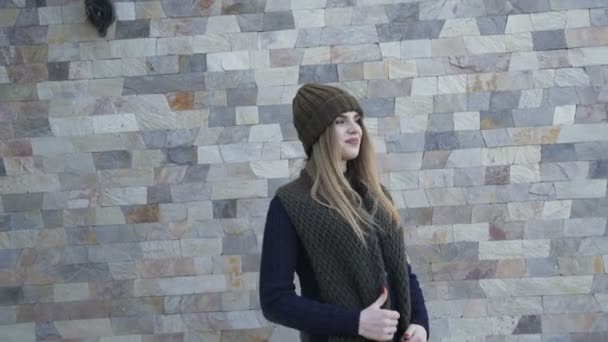 Pretty girl in warm clothes posing on the yard. 4K - Záběry, video