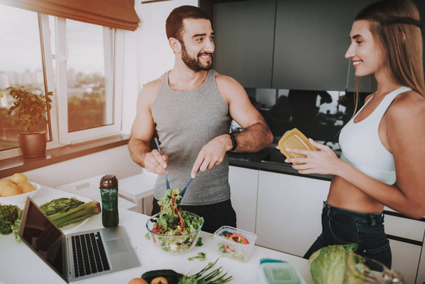 A Couple Is Preparing A Salad For A Breakfast. Cooking Together.. Healthy Lifestyle. Young And Handsome. Sport Body. House Interior. Dish Chopping. Morning Fresh Nutrition Concept. - Zdjęcie, obraz