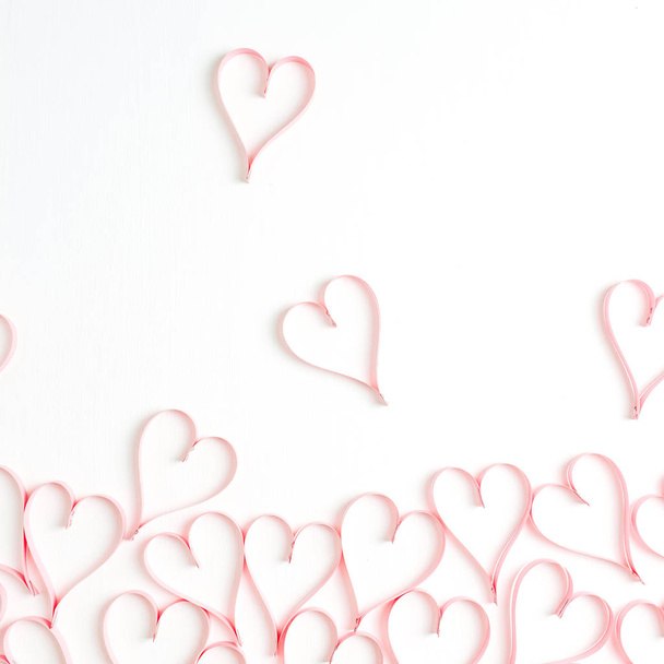 Paper heart symbols on white background. Flat lay, top view Valentines Day background love concept. - 写真・画像