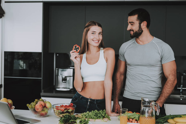 A Couple Is Preparing A Salad For A Breakfast. Cooking Together.. Healthy Lifestyle. Young And Handsome. Sport Body. House Interior. Dish Chopping. Morning Fresh Nutrition Concept. - Valokuva, kuva