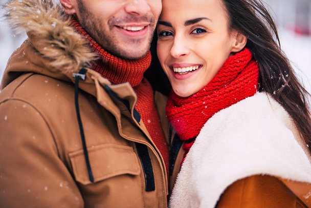 Happy couple posing on winter nature background - Foto, Imagen