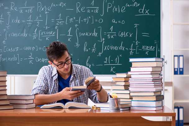 Young male student studying math at school - Photo, Image