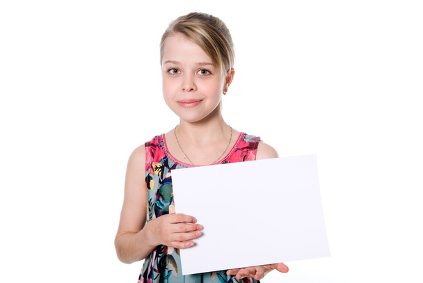Smiling girl standing with empty blank paper in hands - Фото, зображення