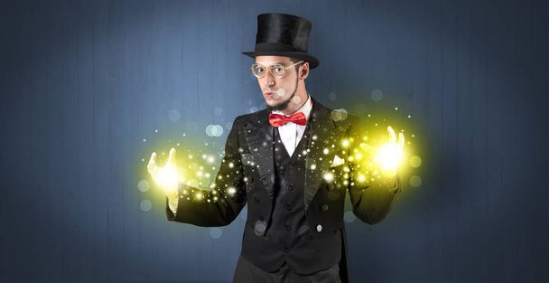 Illusionist holding superpower on his hand - Фото, изображение