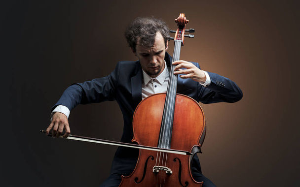 Cellist playing on instrument with empathy - Valokuva, kuva
