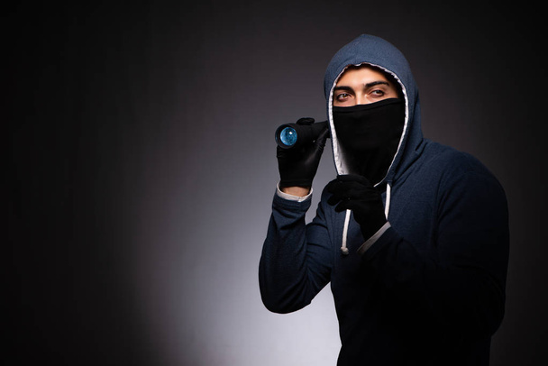Young gangster in hood on grey background  - Foto, Imagem