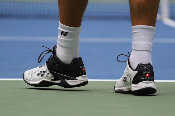NEW YORK - AUGUST 27, 2018:  Grand Slam Champion Stanislas Wawrinka of Switzerland wears custom Yonex tennis shoes during first round match at 2018 US Open at USTA National Tennis Center - Photo, Image